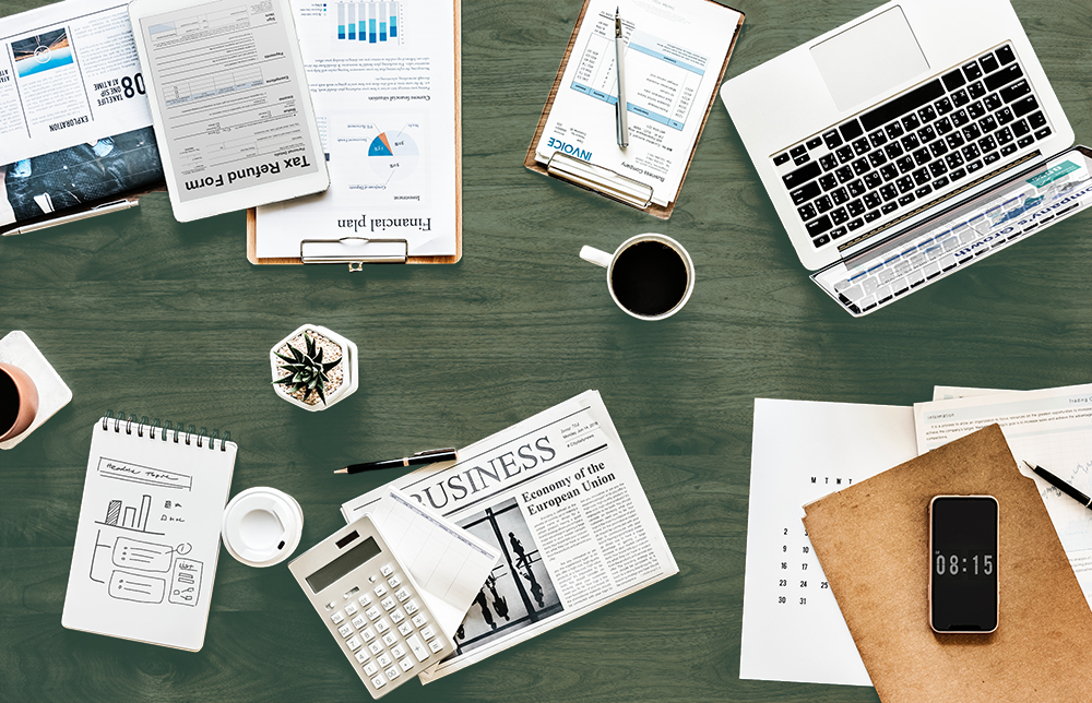 desk flat lay with business documents and computer