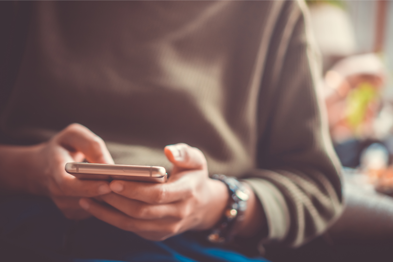 person scrolling facebook on smartphone