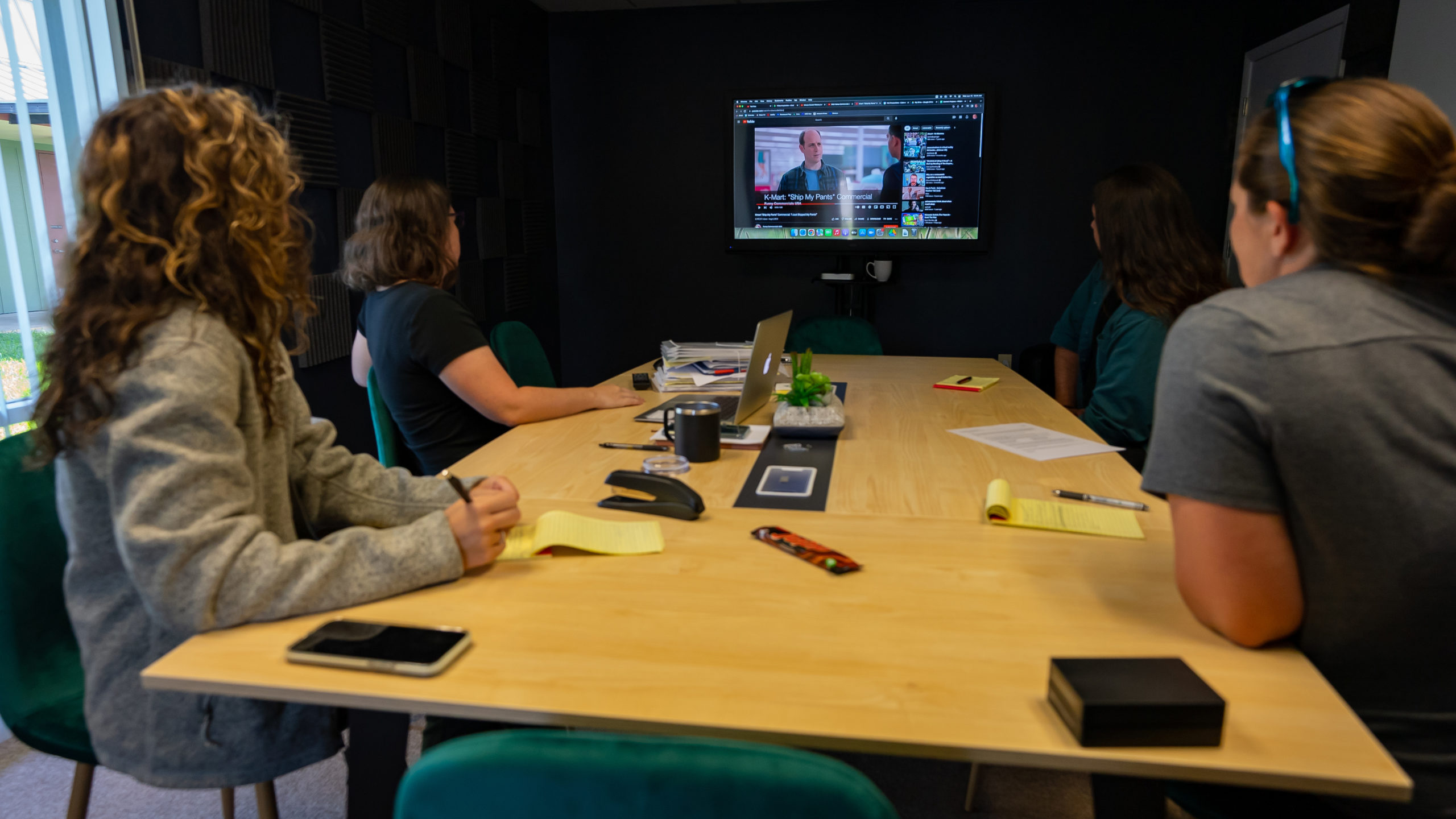 142 productions crew watching video inspiration clips during meeting